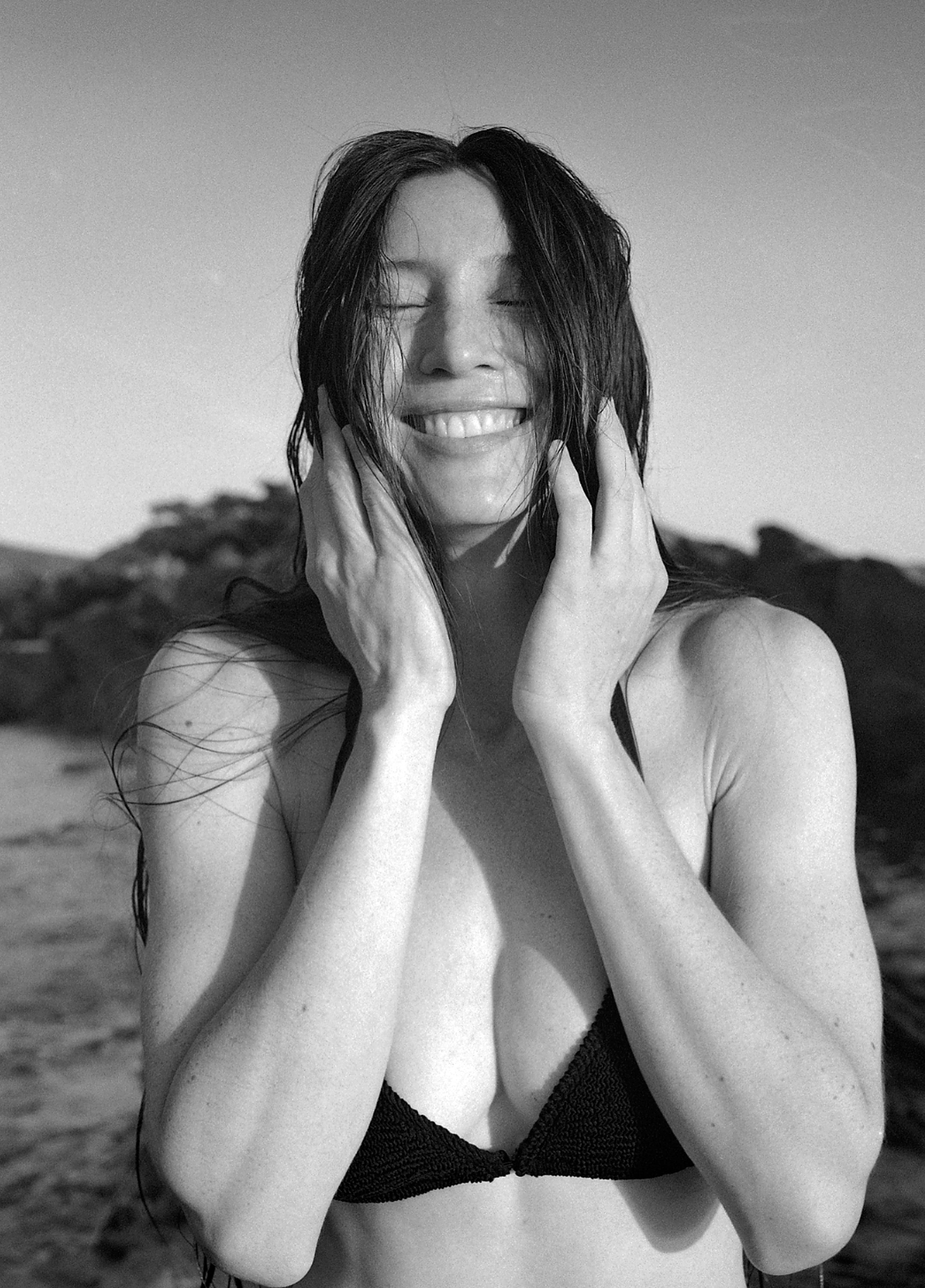 Self-portrait of Kimbra at the beach wearing a Youswim bikini