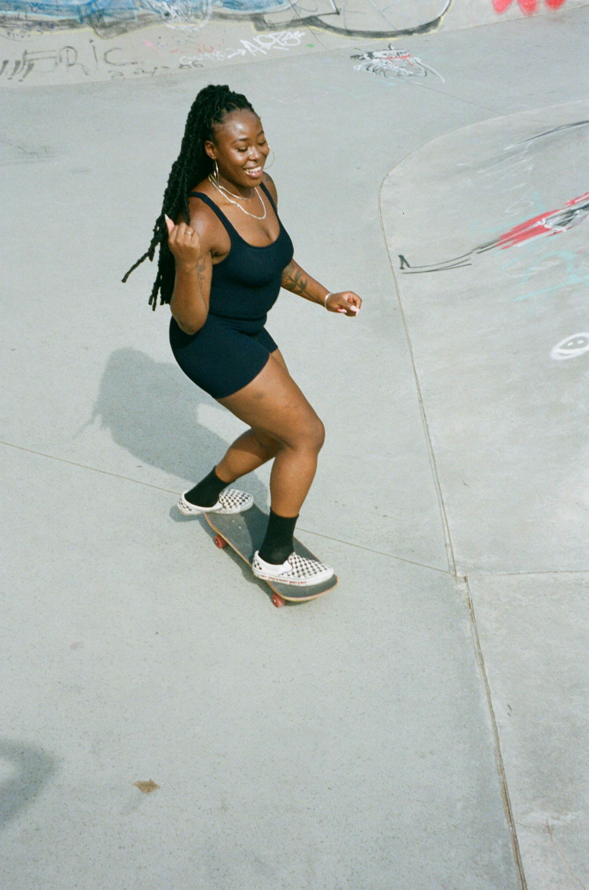 Zuleha skatebaording in blue swimsuit top and shorts