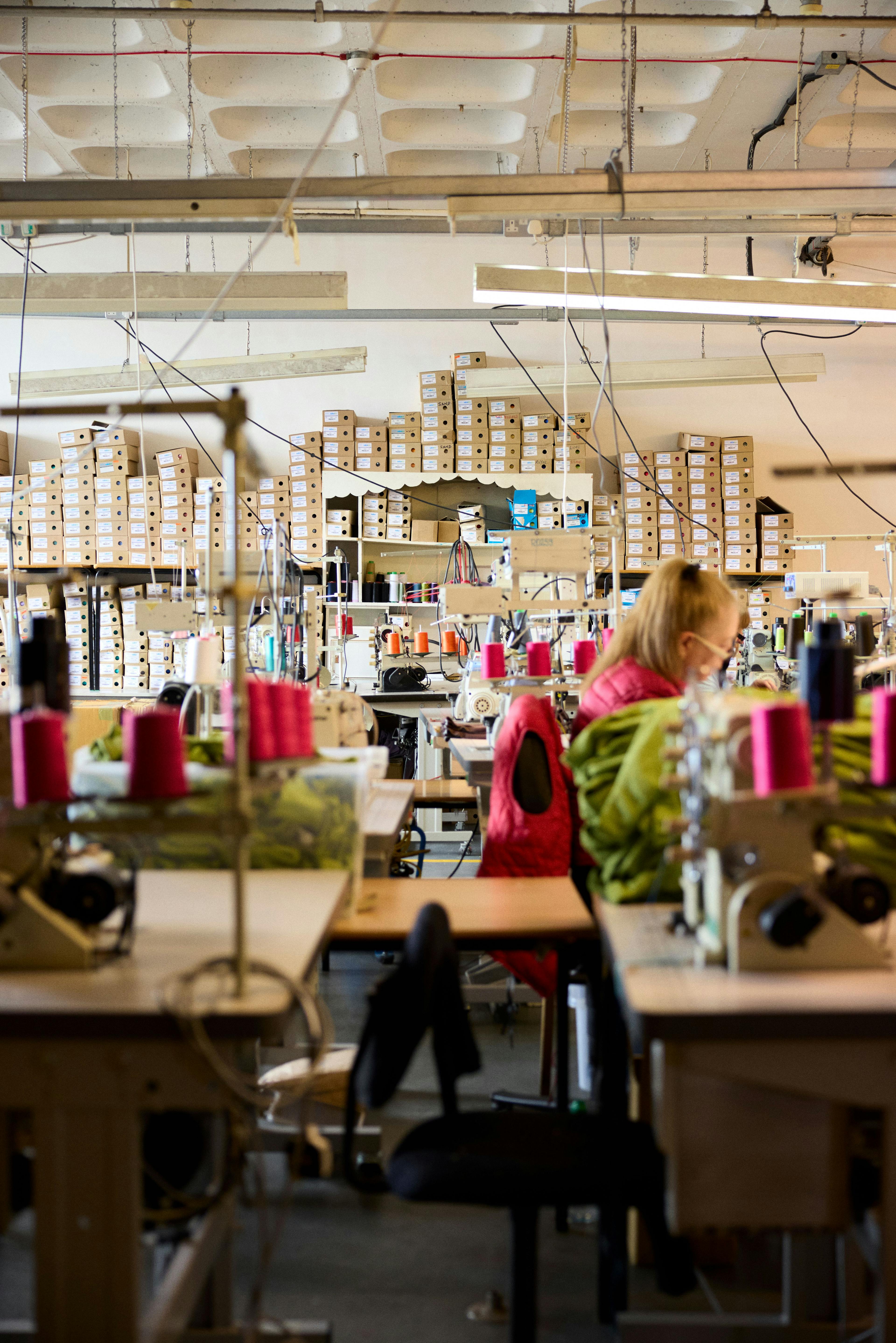 Factory with person sewing swimsuits.